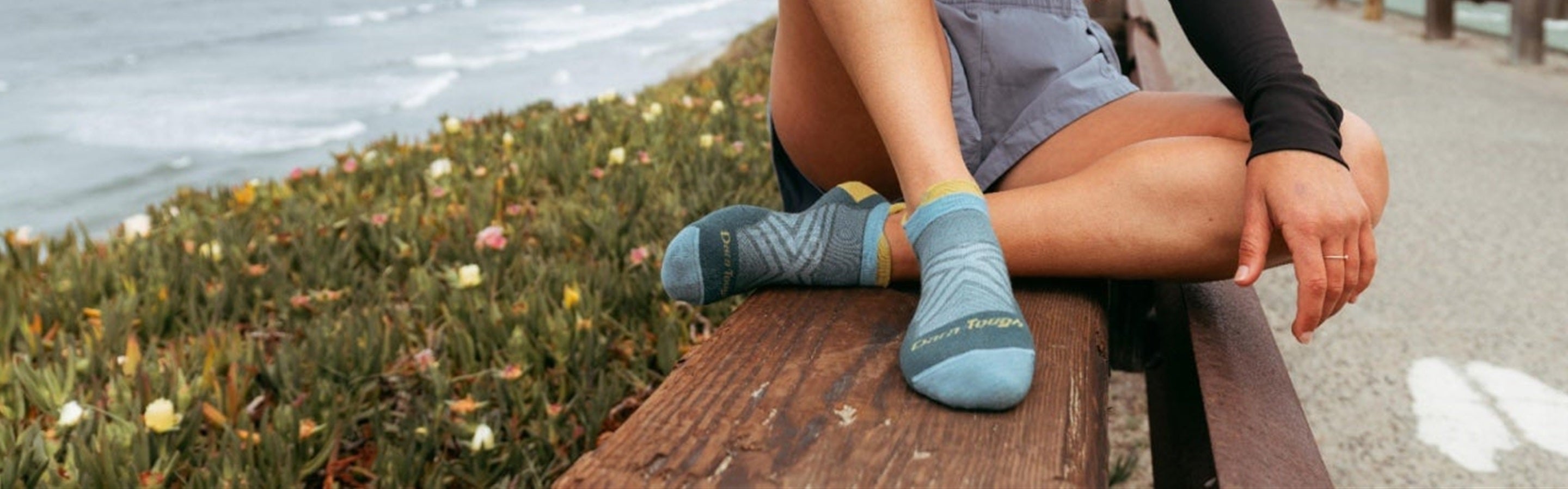 Runner wearing Darn Tough socks by the ocean